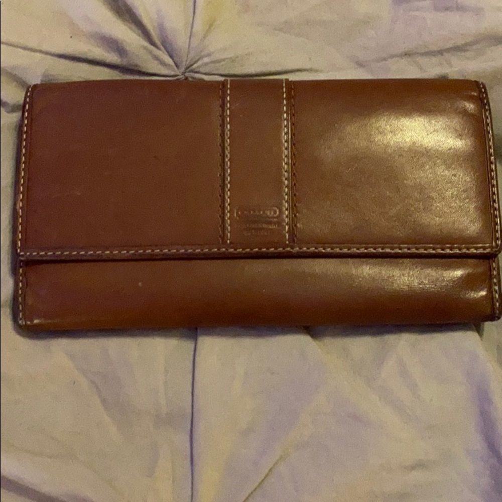 Used condition Coach tan wallet with blue lining.